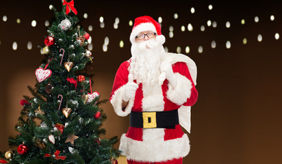 santa claus with bag and christmas tree