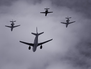 group of four planes flying together in formation