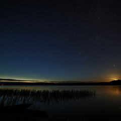 The stars in the night sky over the river.