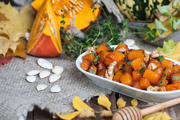 Fried pieces of pumpkin with honey, walnuts and thyme..
