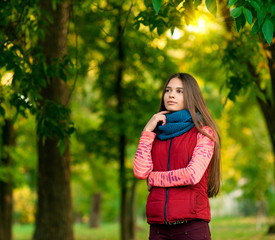 Portrait of pretty girl on the background yellow leaves