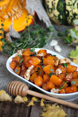 Pieces of caramelized pumpkin with honey, walnuts and thyme..