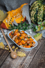 Fototapeta na wymiar Appetizer from caramelized pumpkin with honey, walnut and thyme..