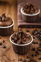 Homemade chocolate cupcakes on wooden background