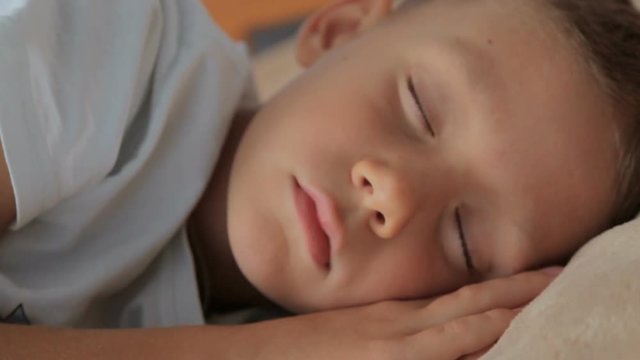 A child sleeps in bed,full hd video
