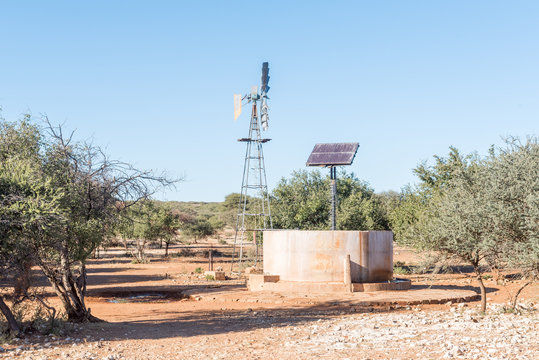 Water-pumping windmill and solar panels for a waterpump