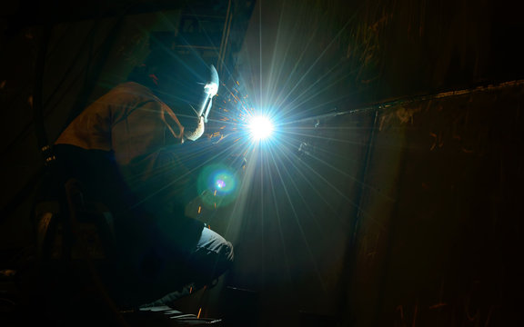 Woman worker welding