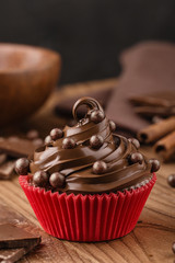 Homemade chocolate cupcake with chocolate chips in red cup