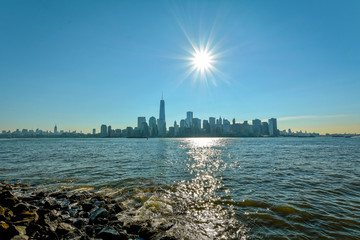 New-York midtown view over Hudson River with blue sky and sun