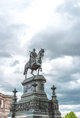 Fototapeta na wymiar Dresden, the ancient capital of Saxony. Monument to King Johann Saxon against the backdrop of a gloomy cloudy sky