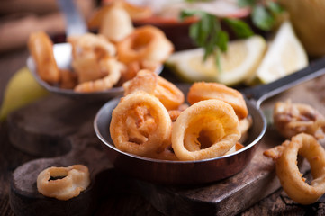 Fried calamari squid on wooden table