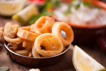 Fried calamari squid on wooden table