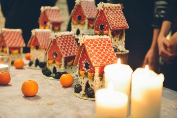 Fototapeta na wymiar Gingerbread house making by hands. Christmas holiday.
