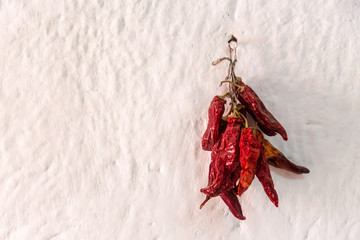 Dried red pepper hanging on a white wall