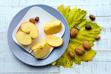 Apple pie with walnuts on gray plate