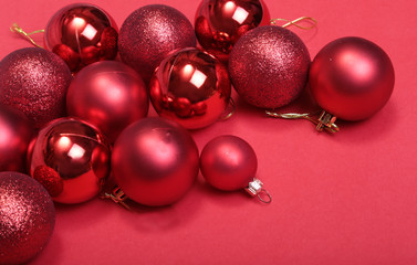 Red christmas balls on a red background