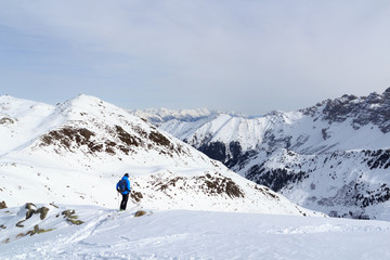 Naklejka na ściany i meble Man on ski looking at mountain snow panorama before downhill in Stubai Alps, Austria