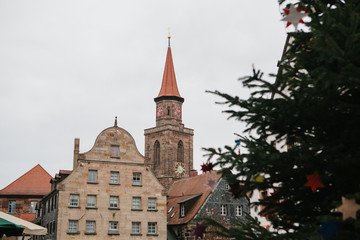 Decorated christmas tree against the backdrop of sights - old traditional buildings in Furth city in Germany