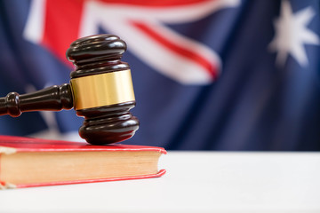 Gavel and legal book on wooden table, collage with flag of australia © yavdat