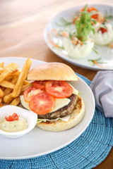 Hamburger and fries served on the restaurant table