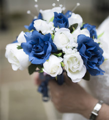 Close up of a blue and white wedding bouquet held by bride