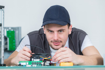electronic engineer repairing electronic devices on broken computer