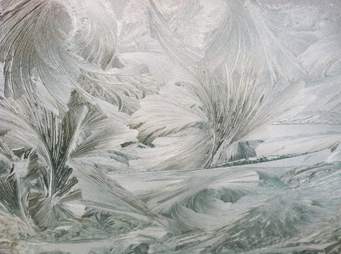 Ice and frost formation with feather pattern on car windshield