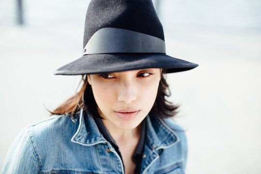 Portrait of beautiful young hispanic woman with hat and jeans jacket