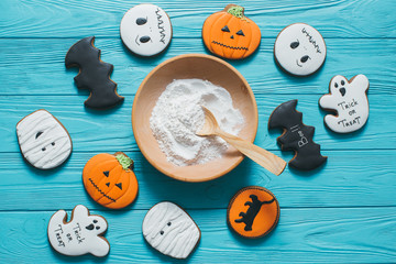 Fresh halloween gingerbread cookies on blue wooden table.