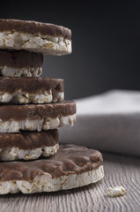 Rice biscuits and crackers in chocolate on the  warm table