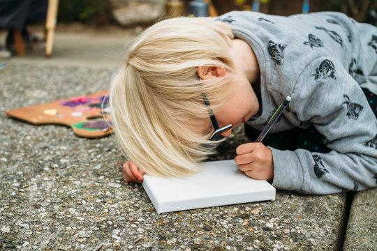 young girl drawing on a canvas