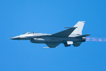 Fototapeta na wymiar F-16 Fighting Falcon flying away, with afterburner on 