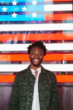 Young Trendy Afro American Man with a Digital USA Flag Backwards in Times Square, New York