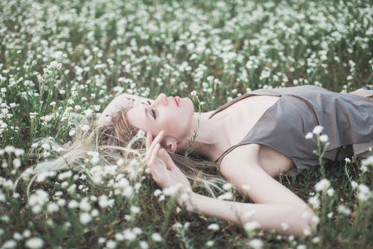 Prretty blond girl laying on the grass