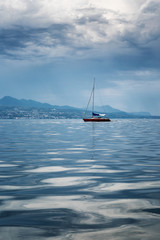 Fototapeta na wymiar Sailing yacht, sea, mountains, blue sky