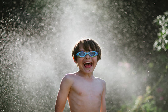 Boy having fun with sprinkler