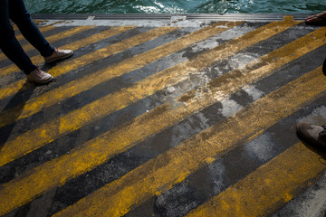 Obraz premium Docks with tourist feet in Venice