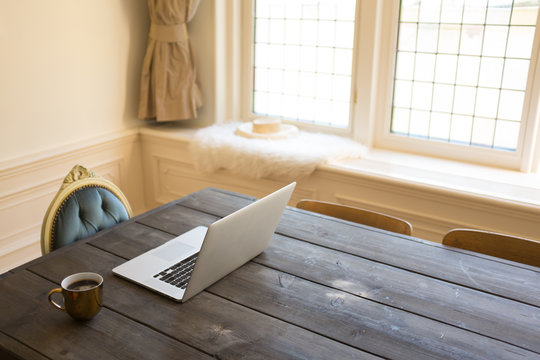 Computer And Coffee On Table At Home Work Station