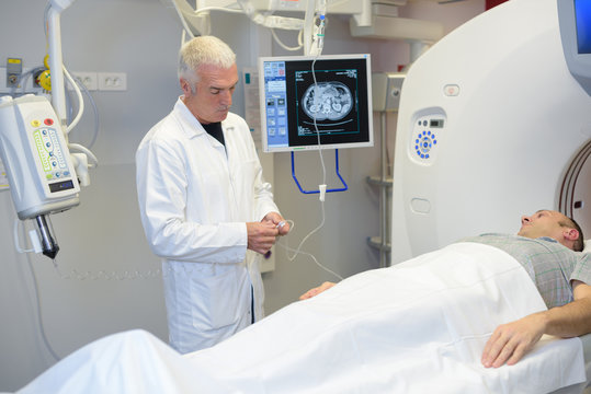 doctor and patient in mri room at hospital