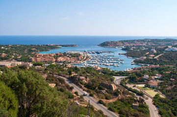 Gulf with the clear sea and the city of Porto Cervo