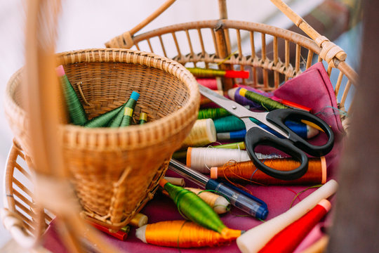 Wicker basket with lots of sewing tools and equipment