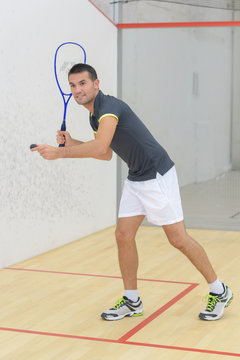 young man is playing indoor tennis