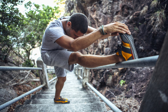 Man Stretching His Leg After a Workout