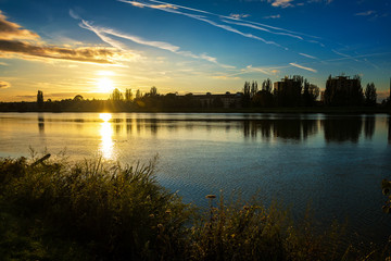 Fototapeta premium Autumn sunset on riverbank of Vah river in Piestany (Slovakia)
