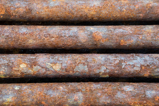 rusted discarded industrial pipes