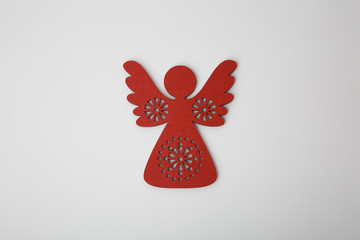 Red wooden christmas angel ornament on white