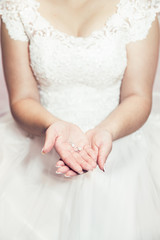 Bride hands holding earrings