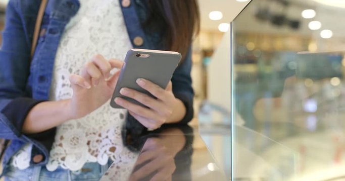 Woman use of smart phone in shopping mall