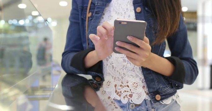 Woman use of mobile phone in shopping mall