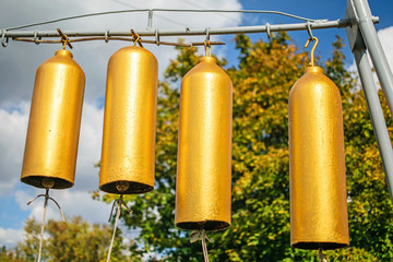 Golden church bells outdoor at sunny autumn day. The city Pokrov, Ukraine